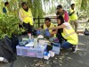 Hub colleagues crouch and stand around equipment from the 'Lab in a suitcase' whilst on the bank of the Ouseburn, preparing water samples for analysis thumbnail